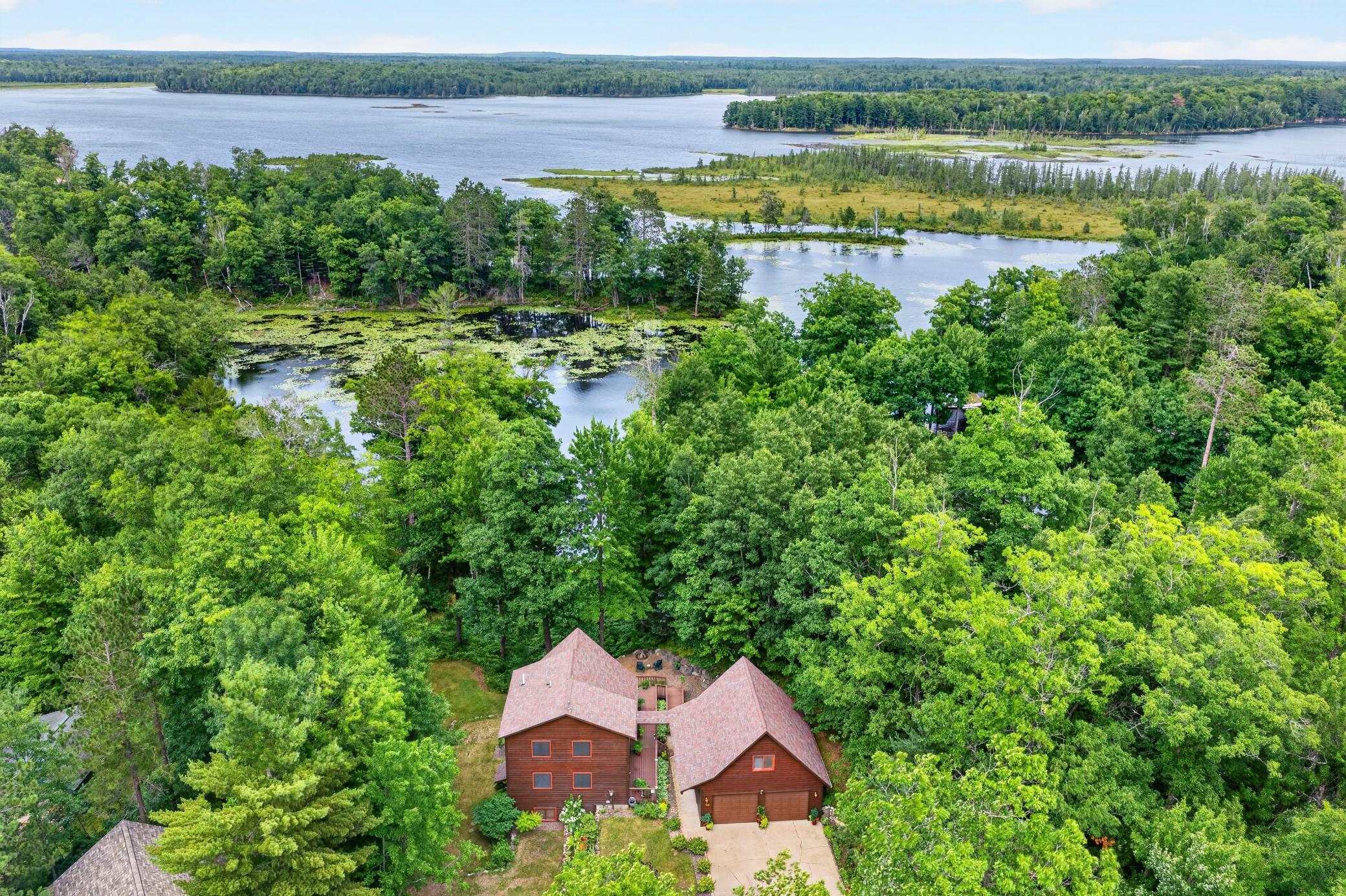 Aerial birds eye view of the lake and lakehome.