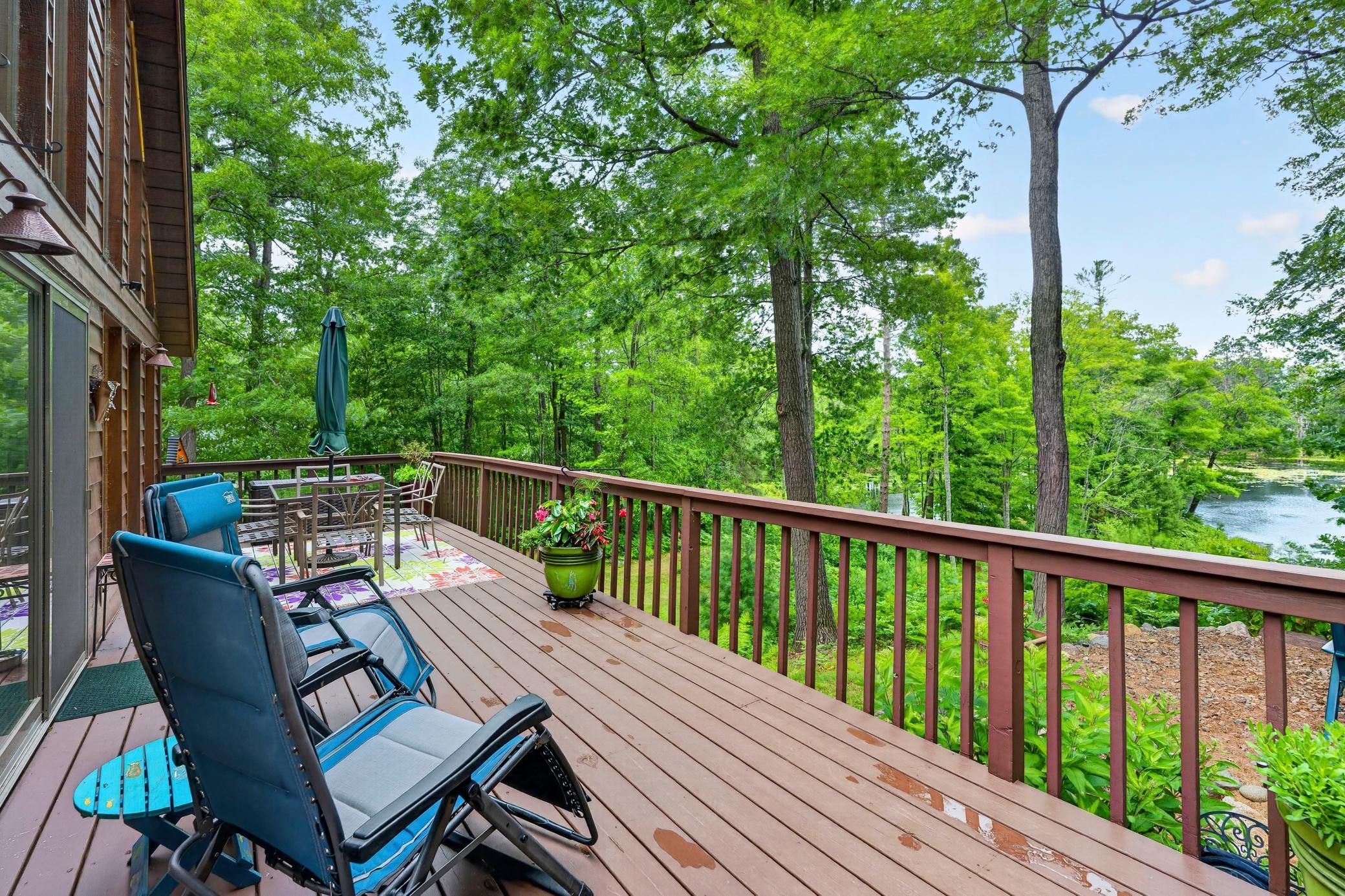 LARGE lakeside deck with sitting and dining areas.