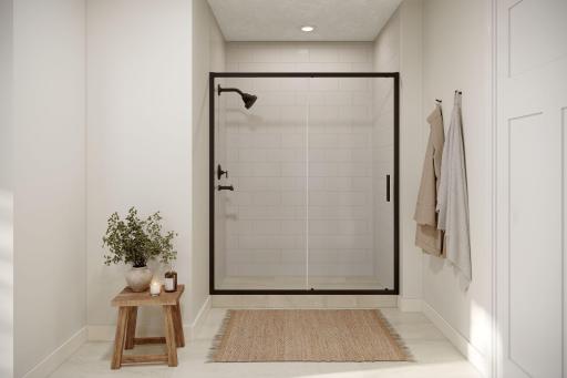 Owner's shower in bathroom - virtually staged. Finishes in actual home are different. Picture used for floorplan purposes.