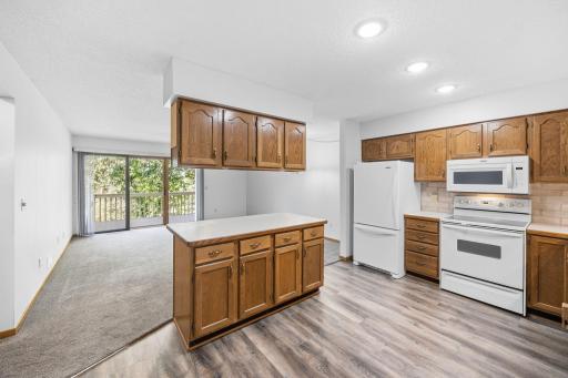 Center island, newer flooring in kitchen.