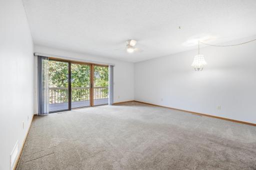 Living room with balcony access. Big windows for natural light.