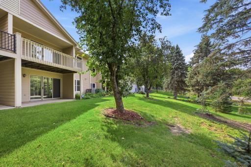 Enjoy views of mature trees from balcony and patio.
