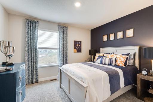 In addition to the primary bedroom, the home's upper level also includes these two additional bedrooms, and another full bathroom just adjacent to each! Photo of model, colors and options will vary.