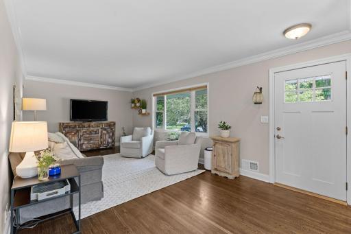 Spacious living room with large window and hardwood floors