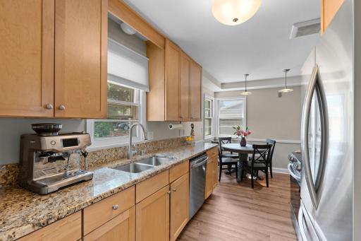 Updated kitchen with granite countertops, maple cabinets, and stainless steel appliances