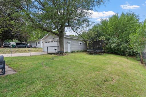 Large, fenced backyard with a patio area and fresh landscaping