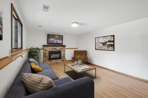 Virtually Staged family room --new laminate flooring