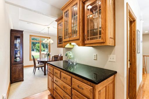 Butler's pantry leading to the formal dining room with custom ceiling