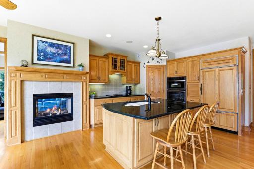 Gourmet kitchen, granite counters, walk-in pantry, dual sided fireplace