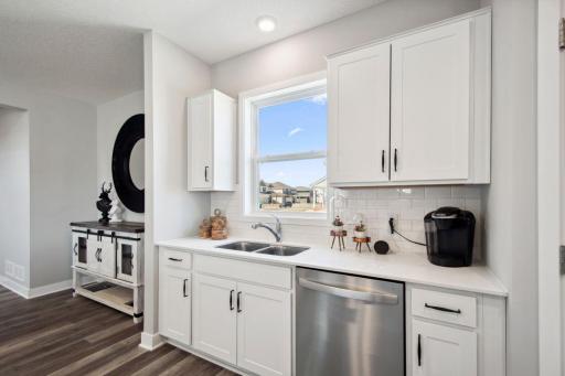 A kitchen built to perform - complete with an oversized island, corner pantry, stainless steel appliance package including a gas range, vented microwave, and dishwasher, with enough space for everyone!