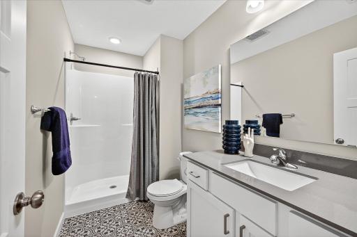 Lower Level Bathroom - photo is of a previous inventory home. Inquire for more details and options.