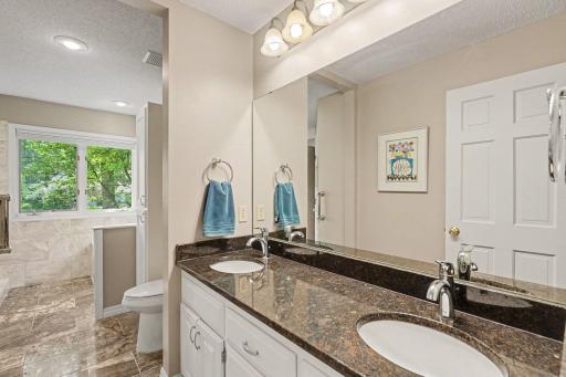 The private, primary full bathroom was completely updated in 2016. It features: marble flooring, a supplemental wall heater (not pictured) next to the walk-in closet, and a Quartz countertop with under-mounted double sinks.