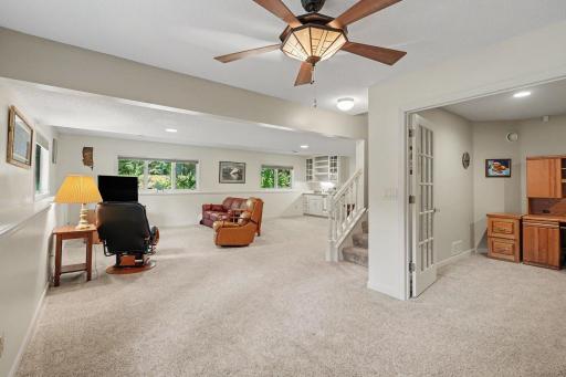 The lower level features a flex room w/glass french doors. Could be used as an office, guest bedroom, or workout room. The family room offers lots of west & north facing windows - overlooking the yard, and a custom built-in wet bar.