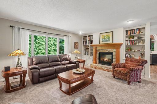 The main floor living room fireplace was entirely replaced in 2017. It features: a stacked stone hearth & surround, a wood mantel, and is flanked by custom built-in bookshelves.