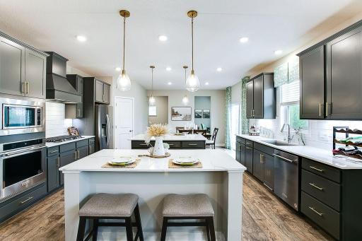Open floor plan on the main level, but has two cozy nooks for office work, one in the front and one off the kitchen! *Photo of previously built model home. Finishes and selections to vary.