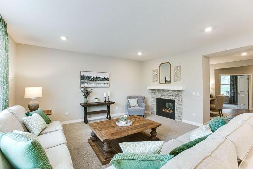 Double sided fireplace. Enough space on the adjacent wall for the television if desired. *Photo of previously built model home. Finishes and selections to vary.