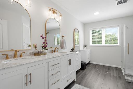 Wow. This bath has been fully modernized. The dual sink vanity. The fixtures. The flooring. The shower. Even the toilet!