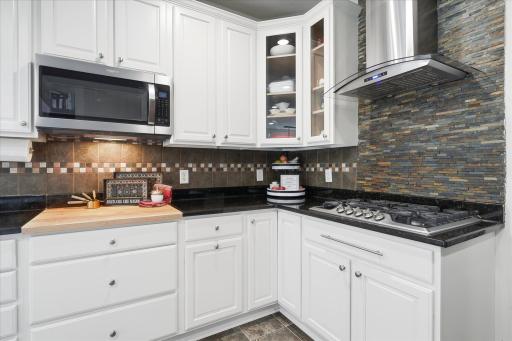 The tile back splash is lovely too, and the 5-burner gas cooktop is vented outside too!