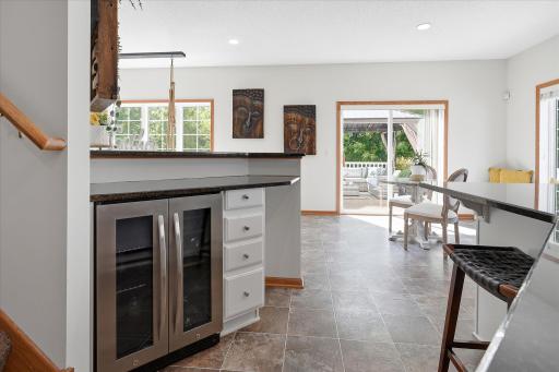 There is a custom peninsula, connected directly to the family room, with granite tops and a beverage cooler.