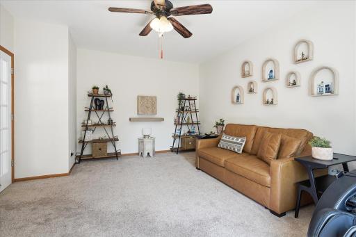The modern & neutral carpet & paint make this space so bright & cheery, and the air keeps moving because of that ceiling fan!