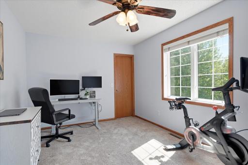 This is the 2nd of 2 rear facing upper level bedrooms, and it features a ceiling fan, a walk-in closet and modern & neutral paint & carpet.