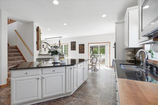 Modernized white cabinets. Contrasting black granite countertops. High end stainless steel appliances. Love love love!