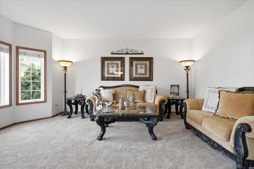 The formal living room has neutral & modern carpet & paint.