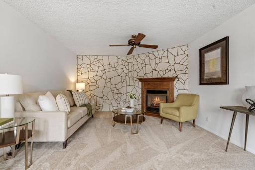 Living Room provides another inviting gathering space with a gas fireplace, window seat & new carpet