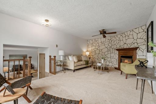 Living Room provides another inviting gathering space with a gas fireplace, window seat & new carpet
