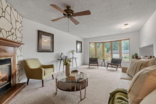 Living Room provides another inviting gathering space with a gas fireplace, window seat & new carpet
