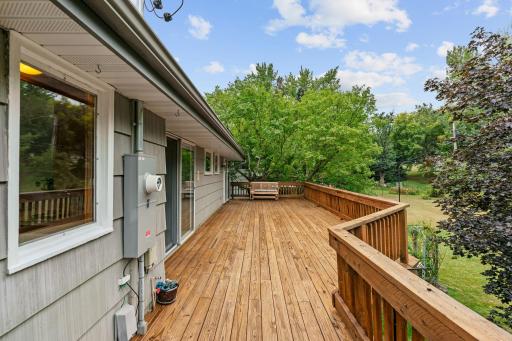 Walkout to oversized deck withprivate backyard w/ mature trees