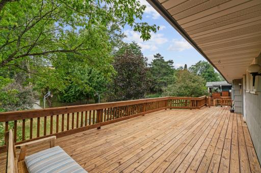Walkout to oversized deck withprivate backyard w/ mature trees