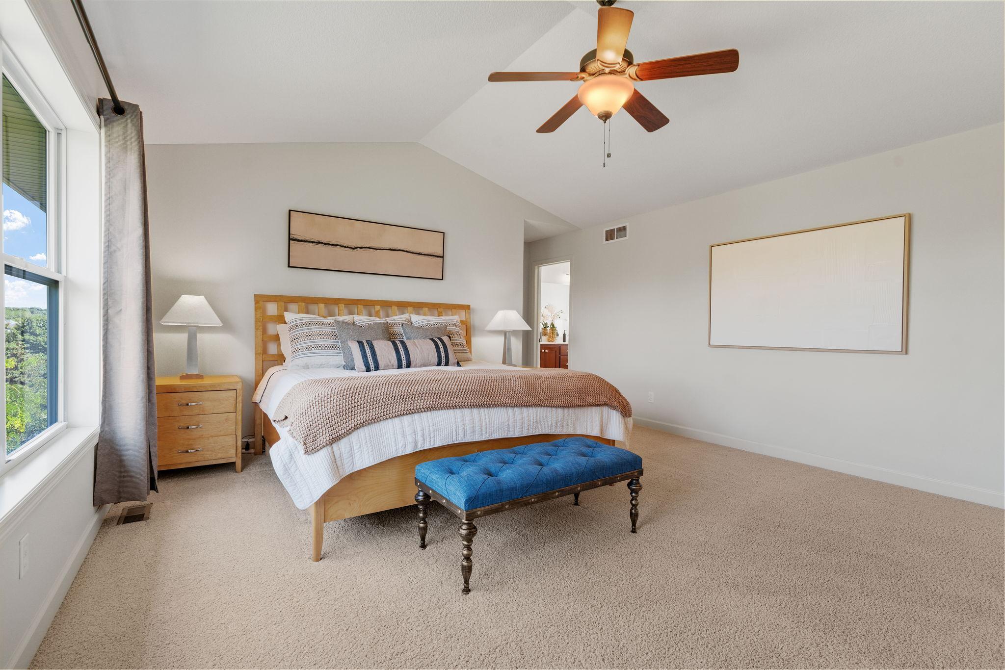 Spacious Primary Suite w/ vaulted ceiling, oversized walk-in closet, dual sinks + separate tub/shower