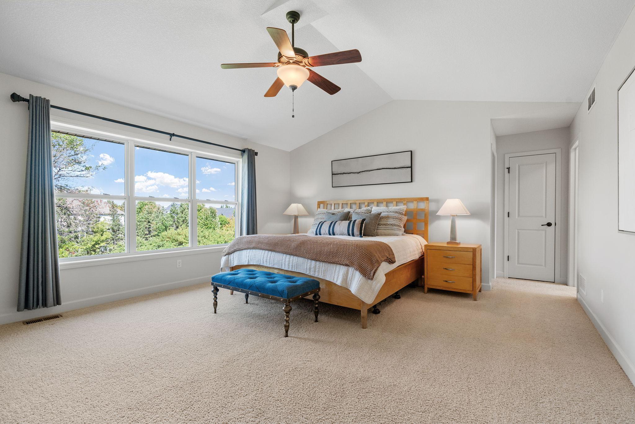 Spacious Primary Suite w/ vaulted ceiling, oversized walk-in closet, dual sinks + separate tub/shower