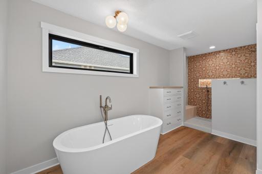 Floating tub and built-in dresser in the bathroom!