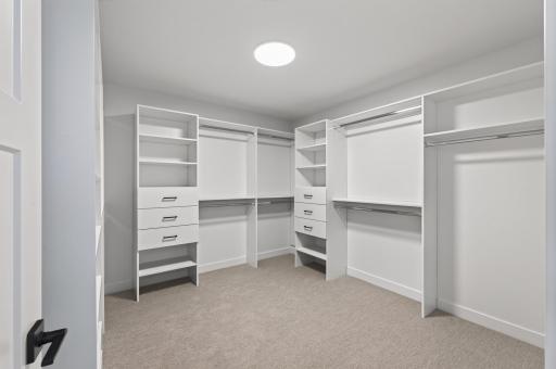 Primary bedroom walk-in closet