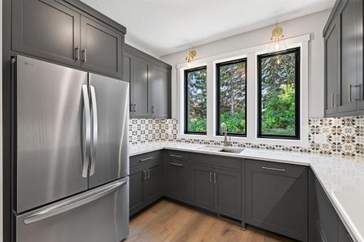 This butler's pantry is stocked with a dishwasher, sink and a full size fridge! A chef's dream!