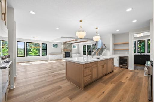 Open concept kitchen, dining, and living room areas