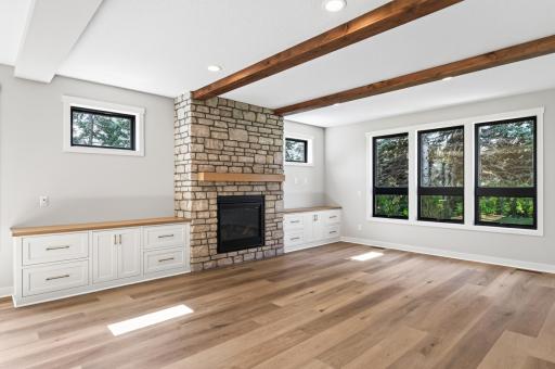 Living room with built ins, gorgeous wood beams and 9" LVP planks