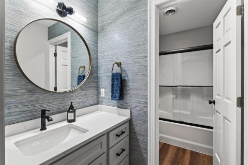 Separate tub/sink areas in the upper level common bathroom