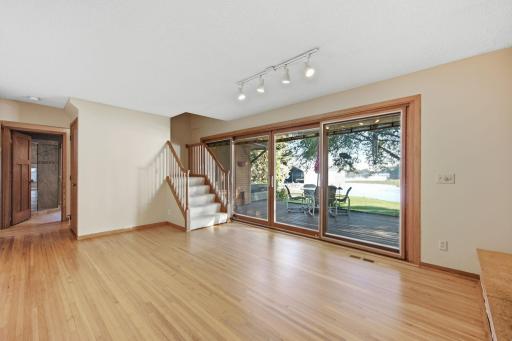 Great room open to kitchen. Stairs lead to the primary bedroom suite, added in the early 1990's.
