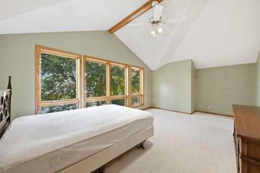 Primary suite features newer windows, vaulted ceilings