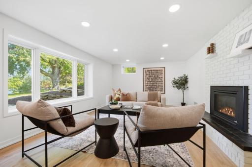 The lower level family room has new gyp board ceiling and walls, lighting, paint, and baseboards.