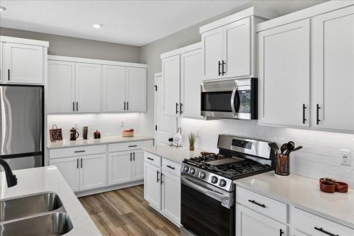 PHOTO OF A DIFFERENT HOME WITH SIMILAR PLAN AND FINISHES. Kitchen features Soft Close Doors and Drawers.