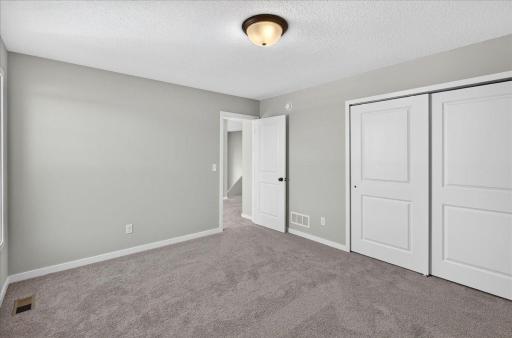 PHOTO OF A DIFFERENT HOME WITH SIMILAR PLAN AND FINISHES. Bedroom 2.