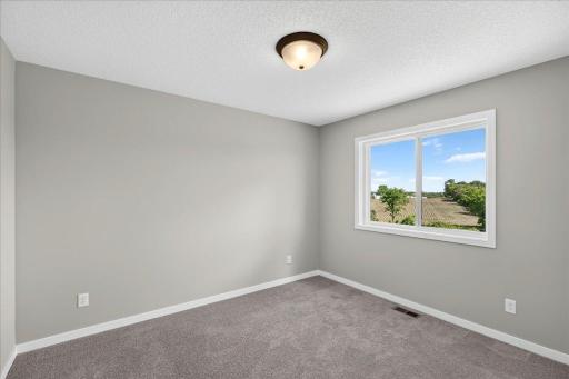 PHOTO OF A DIFFERENT HOME WITH SIMILAR PLAN AND FINISHES. Bedroom 4.