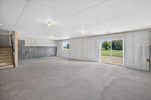 PHOTO OF A DIFFERENT HOME WITH SIMILAR PLAN AND FINISHES. Unfinished Walkout Lower Level ready for future finish including future family, bedroom 5, Bathroom 4, and storage.