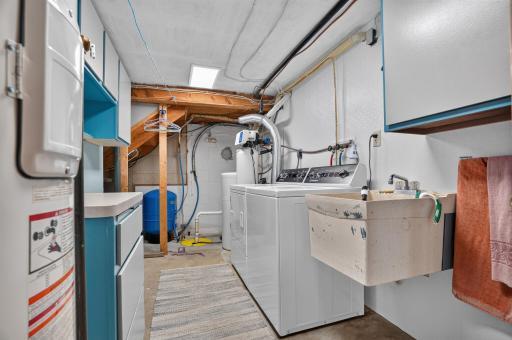 Laundry room offers a deep sink, Newer Speed Queen Commercial washer & electric dryer, new expansion tank, 80 gallon water heater.