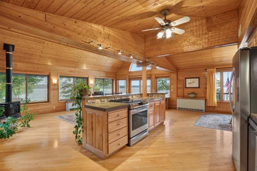 Open design kitchen and vaulted Great Room in knotty pine. Amazing lake views from 3 sides.