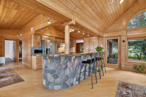 Stone covered island and breakfast bar & a beautiful hickory kitchen